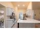 Bright kitchen features white cabinets and stainless steel appliances at 25 Nw 45Th Loop, Ocala, FL 34475