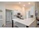 Well-lit kitchen with white cabinets, stylish backsplash, and peninsula at 25 Nw 45Th Loop, Ocala, FL 34475