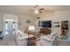 Open concept living room with vaulted ceilings and neutral color palette at 25 Nw 45Th Loop, Ocala, FL 34475