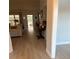 Bright living room with light wood floors and doorway leading to a screened lanai at 25 Nw 45Th Loop, Ocala, FL 34475