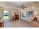 Large main bedroom with tray ceilings, neutral carpet, and ample natural light at 25 Nw 45Th Loop, Ocala, FL 34475