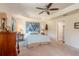 Cozy main bedroom with tray ceilings, neutral carpet, and tasteful decor at 25 Nw 45Th Loop, Ocala, FL 34475