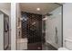 Modern shower featuring striking tile design, shower seat, and frameless glass surround at 25 Nw 45Th Loop, Ocala, FL 34475