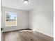 Well-lit bedroom with wood-look flooring and large window at 7128 Sw 134Th St, Ocala, FL 34473