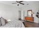 Bedroom with wooden dresser and large bed, neutral colors at 7128 Sw 134Th St, Ocala, FL 34473