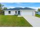 Newly constructed one-story home with a two-car garage and landscaped lawn at 7128 Sw 134Th St, Ocala, FL 34473