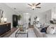 Modern living room with hardwood floors, open layout, and a view to dining area at 7128 Sw 134Th St, Ocala, FL 34473