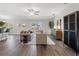 Open concept living area with hardwood floors, a neutral color palette, and modern furniture at 7128 Sw 134Th St, Ocala, FL 34473