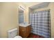 Cozy bathroom features a vanity with a wood cabinet and a shower with a striped curtain at 4560 Sw 52Nd Cir # 101, Ocala, FL 34474