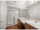 Bright bathroom with double sink vanity, shower, and wood look flooring at 4560 Sw 52Nd Cir # 101, Ocala, FL 34474