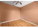 Unfurnished bedroom with wooden floor, painted salmon walls, and a ceiling fan at 4560 Sw 52Nd Cir # 101, Ocala, FL 34474
