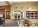 Open common area with a bar, kitchen, comfortable seating, and a built-in bookcase at 4560 Sw 52Nd Cir # 101, Ocala, FL 34474