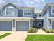 Charming townhome showcasing a well-maintained exterior with a garage and landscaping at 4560 Sw 52Nd Cir # 101, Ocala, FL 34474