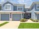 Charming townhome showcasing a well-maintained exterior with a garage and landscaping at 4560 Sw 52Nd Cir # 101, Ocala, FL 34474
