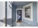 Blue front door with a wreath and a window on the porch with textured blue walls at 4560 Sw 52Nd Cir # 101, Ocala, FL 34474