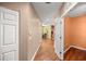 Bright hallway with hardwood floors and a view of the dining room at 4560 Sw 52Nd Cir # 101, Ocala, FL 34474