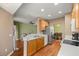 Open-concept kitchen with hardwood floors, stainless steel appliances, and modern finishes at 4560 Sw 52Nd Cir # 101, Ocala, FL 34474