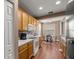 Well-lit kitchen features hardwood floors, oak cabinets, and updated appliances at 4560 Sw 52Nd Cir # 101, Ocala, FL 34474