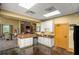 Charming kitchenette with granite countertops, white cabinetry, and a cozy dining area at 4560 Sw 52Nd Cir # 101, Ocala, FL 34474