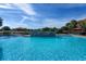 Inviting community pool with a water feature, sun loungers, and lush landscaping at 4560 Sw 52Nd Cir # 101, Ocala, FL 34474