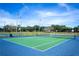 Well-maintained tennis court with a vibrant blue and green surface at 4560 Sw 52Nd Cir # 101, Ocala, FL 34474