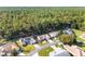 An aerial view showing the home and neighboring properties surrounded by mature trees and lush greenery at 11696 Sw 71St Cir, Ocala, FL 34476