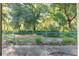 A view of the large backyard, featuring mature trees and a chain link fence at 11696 Sw 71St Cir, Ocala, FL 34476