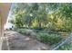 A view of the backyard, with mature trees and greenery visible beyond the chain link fence at 11696 Sw 71St Cir, Ocala, FL 34476