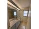 Bathroom with a window and a sink with a large mirror at 11696 Sw 71St Cir, Ocala, FL 34476