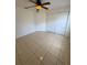 Bedroom with a ceiling fan and a closet, featuring neutral-colored tile flooring at 11696 Sw 71St Cir, Ocala, FL 34476