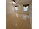 Bedroom featuring tile floors, dual windows and ceiling fan; neutral color scheme creates a welcoming ambiance at 11696 Sw 71St Cir, Ocala, FL 34476