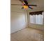 Bedroom featuring tile floors, a ceiling fan, and a closet with white bi-fold doors at 11696 Sw 71St Cir, Ocala, FL 34476