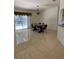 Dining room with tile flooring, sliding glass door, and dark wooden table at 11696 Sw 71St Cir, Ocala, FL 34476