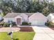 Charming single Gathering home featuring a two-car garage and manicured landscaping at 11696 Sw 71St Cir, Ocala, FL 34476