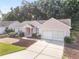 Inviting single Gathering home featuring a two-car garage and mature landscaping at 11696 Sw 71St Cir, Ocala, FL 34476