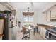 Eat-in kitchen with stainless steel appliances, neutral cabinets, and a light-filled window at 11696 Sw 71St Cir, Ocala, FL 34476
