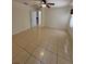 Bright living room with tile flooring, ceiling fan, and neutral paint, offering a clean and inviting space at 11696 Sw 71St Cir, Ocala, FL 34476