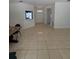 Spacious living room featuring tile flooring and ample natural light coming from front entrance at 11696 Sw 71St Cir, Ocala, FL 34476