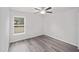 Bedroom with a ceiling fan, neutral walls and a sunny window at 24381 Nw Falcon Ave, Dunnellon, FL 34432