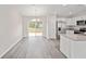 Dining area offers modern flooring, a stylish chandelier, and seamless access to the backyard at 24381 Nw Falcon Ave, Dunnellon, FL 34432