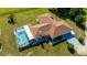 Stunning aerial view of home with screened pool and ample lawn space, nestled in a lush green landscape at 174 Juniper Trl, Ocala, FL 34480