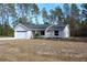 Newly built home with a two-car garage and a front yard at 202 Guava Pass, Ocklawaha, FL 32179