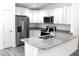 Bright kitchen with stainless steel refrigerator and a granite countertop island at 202 Guava Pass, Ocklawaha, FL 32179