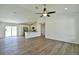 Open concept living room with kitchen featuring modern appliances, and wood-look flooring at 202 Guava Pass, Ocklawaha, FL 32179