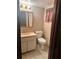 Compact bathroom featuring a single vanity, toilet, and medicine cabinet with a window at 3507 E Fort King St # 235, Ocala, FL 34470