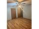 Bedroom with wood floors, ceiling fan, and closet with bi-fold doors at 3507 E Fort King St # 235, Ocala, FL 34470