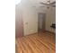 This bedroom features warm wood-look floors and a ceiling fan at 3507 E Fort King St # 235, Ocala, FL 34470