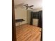 Bedroom features wood flooring, ceiling fan, window, and built-in desk at 3507 E Fort King St # 235, Ocala, FL 34470