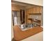 Kitchenette featuring stainless refrigerator, stainless sink, and wood cabinets at 3507 E Fort King St # 235, Ocala, FL 34470