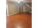 Spacious living room with hardwood floors, ceiling fan, and staircase access at 3507 E Fort King St # 235, Ocala, FL 34470